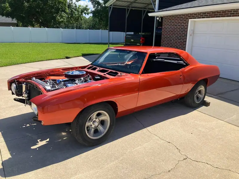Orange classic Camaro restoration detail in a Jacksonville driveway