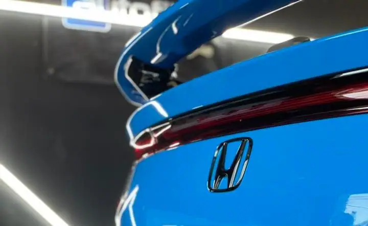 Close-up of the rear wing and badge on a blue Honda after a Maxx Perfection detail