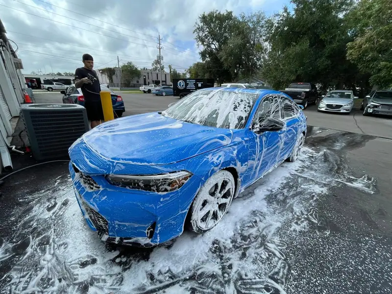 Blue Honda covered in pH-neutral foam during a hand wash by Maxx Perfection Detailing in Jacksonville
