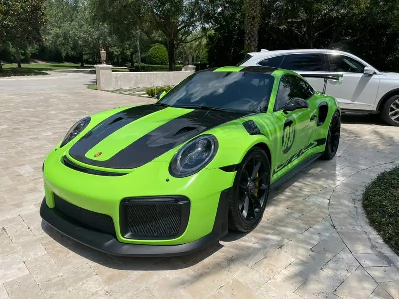Green Porsche GT2 RS detailed on a paver driveway in the Jacksonville area