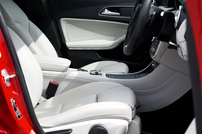Clean pale leather front seats and door card after an interior detail