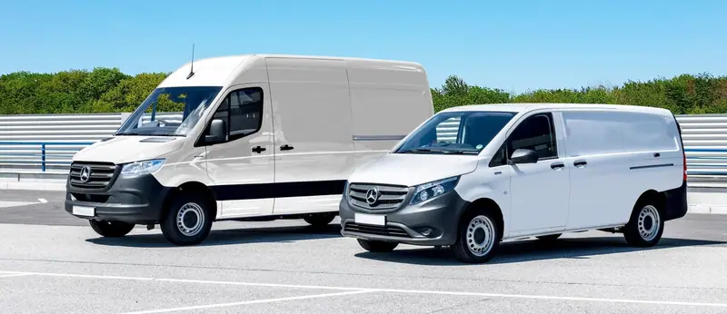 Two white work vans parked side by side, the kind of fleet we keep clean