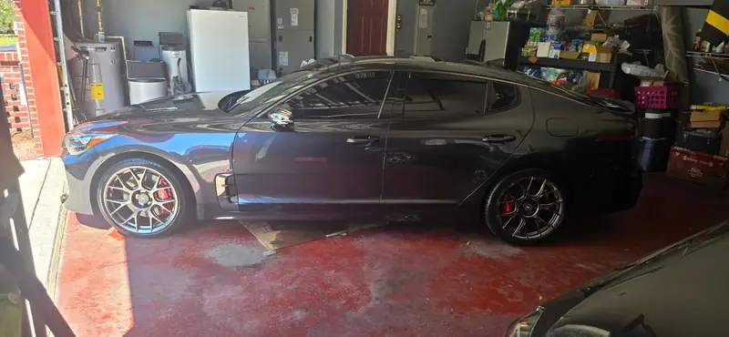Kia Stinger with fresh paint correction and ceramic coating in a home garage